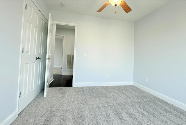 unfurnished bedroom with carpet flooring, baseboards, visible vents, and ceiling fan