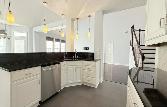 kitchen featuring white cabinetry, pendant lighting, sink, and stainless steel dishwasher