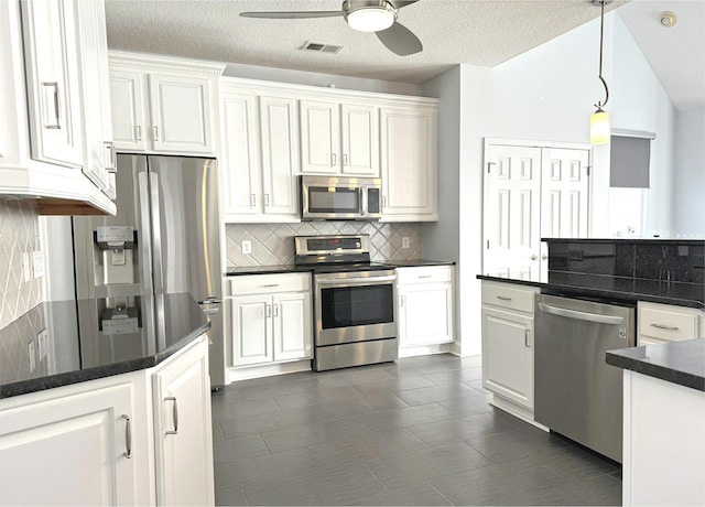 kitchen featuring visible vents, backsplash, a ceiling fan, white cabinets, and appliances with stainless steel finishes