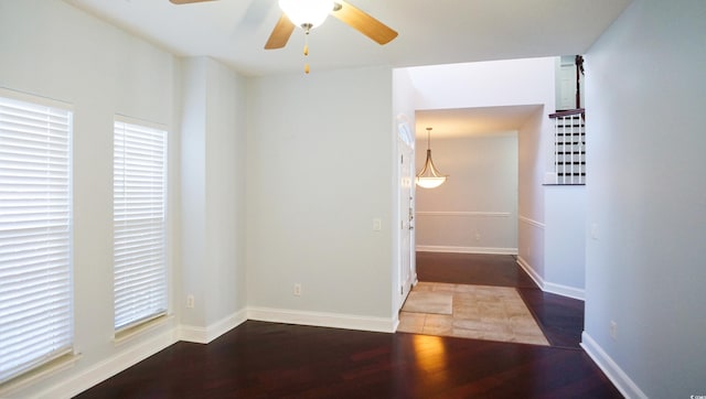 spare room with ceiling fan and dark hardwood / wood-style floors