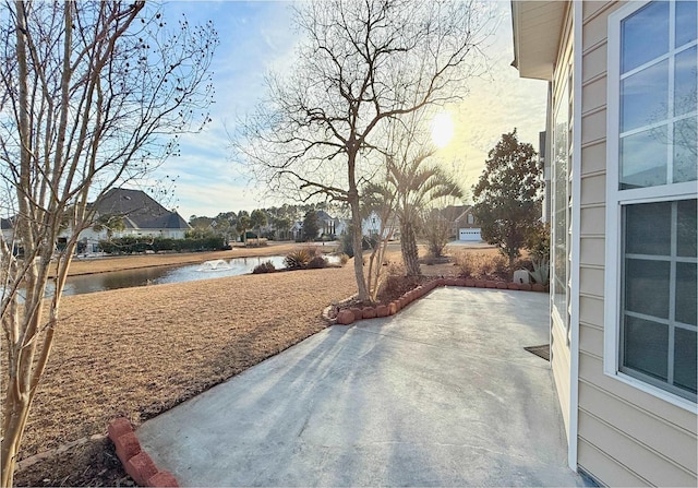 view of patio with a water view