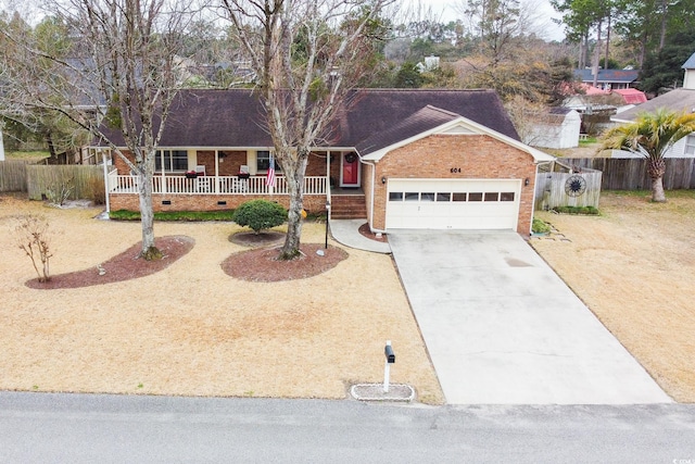 ranch-style home with a porch and a garage