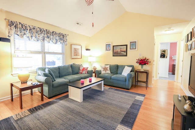 living room with lofted ceiling and light wood-type flooring