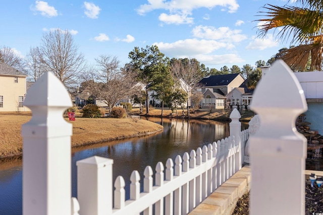 property view of water featuring a residential view and fence