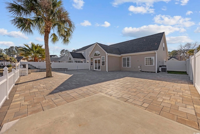 back of property featuring cooling unit and a patio