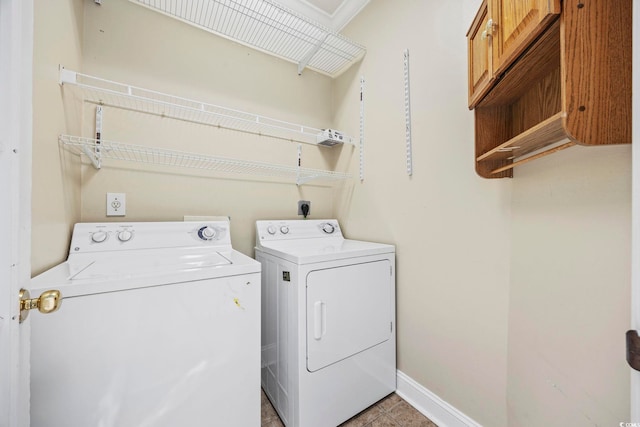 washroom featuring cabinets and independent washer and dryer