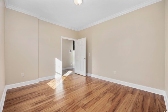 unfurnished room featuring ornamental molding and hardwood / wood-style floors