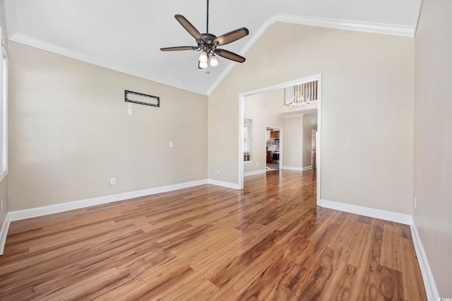 unfurnished room featuring hardwood / wood-style floors, high vaulted ceiling, ornamental molding, and ceiling fan