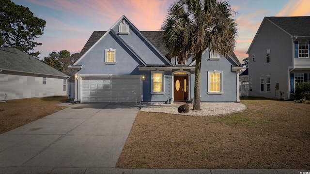 view of front facade with a garage and a yard