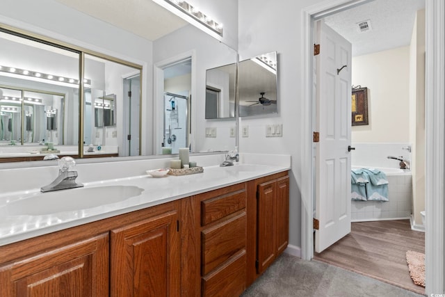 4396 Baldwin Ave Unit 94, Little River, SC 29566 - bathroom with double vanity, a ceiling fan, a bath, baseboards, and a shower