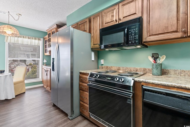 4396 Baldwin Ave Unit 94, Little River, SC 29566 - kitchen featuring black appliances, wood finished floors, light countertops, a textured ceiling, and decorative light fixtures