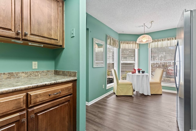 4396 Baldwin Ave Unit 94, Little River, SC 29566 - kitchen with freestanding refrigerator, light countertops, dark wood finished floors, a textured ceiling, and hanging light fixtures