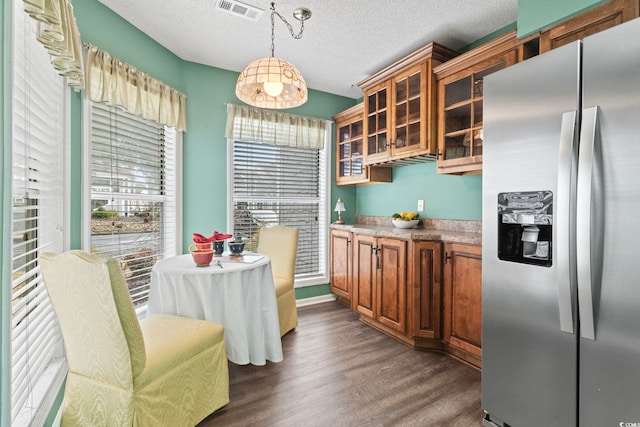 4396 Baldwin Ave Unit 94, Little River, SC 29566 - kitchen with stainless steel fridge with ice dispenser, brown cabinetry, dark wood-type flooring, glass insert cabinets, and a textured ceiling