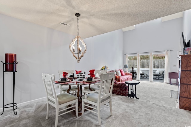 4396 Baldwin Ave Unit 94, Little River, SC 29566 - carpeted dining area with a chandelier, a textured ceiling, and a towering ceiling