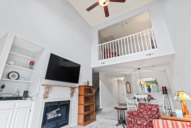 4396 Baldwin Ave Unit 94, Little River, SC 29566 - living area featuring high vaulted ceiling, a ceiling fan, a tile fireplace, stairs, and baseboards