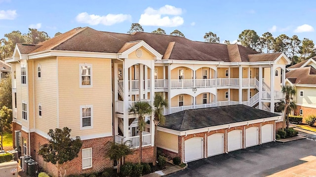 view of property with a garage and driveway