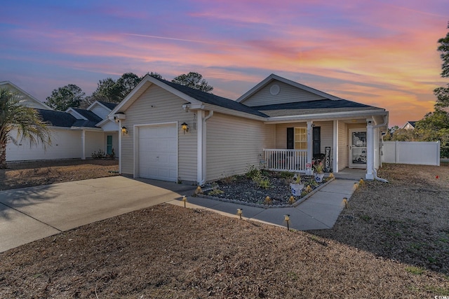 ranch-style home featuring a garage and a porch