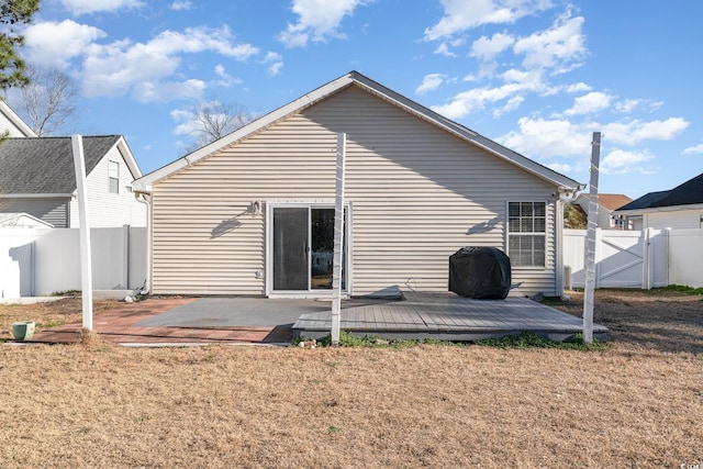 back of house with a patio, a yard, and a deck