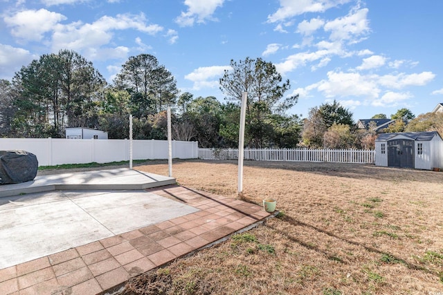 view of yard with a storage shed and a patio area