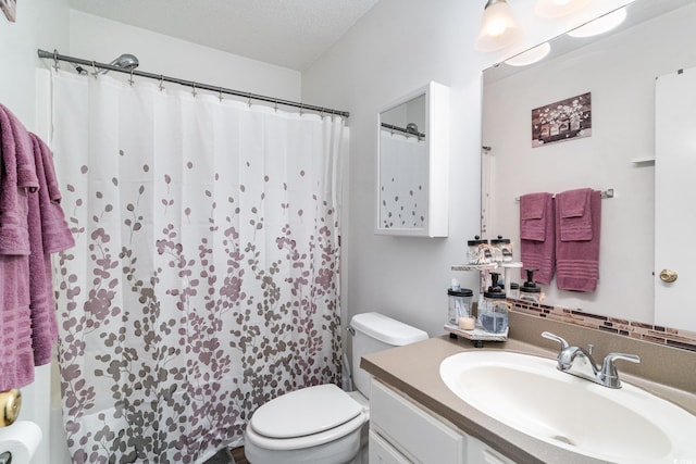 bathroom featuring a shower with curtain, vanity, a textured ceiling, and toilet