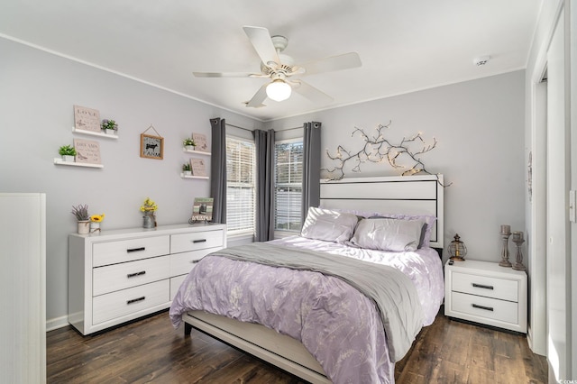 bedroom with dark hardwood / wood-style flooring, crown molding, and ceiling fan