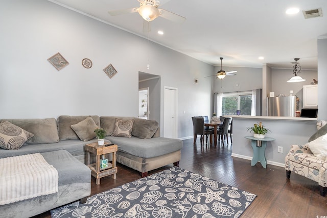 living room featuring lofted ceiling, dark wood-type flooring, ornamental molding, and ceiling fan