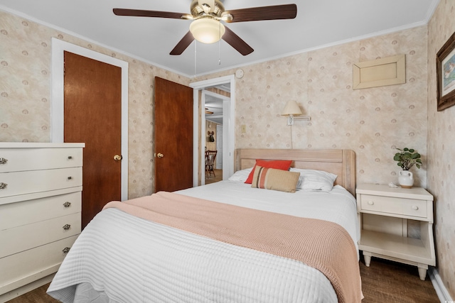 bedroom with ceiling fan, wood finished floors, baseboards, ornamental molding, and wallpapered walls