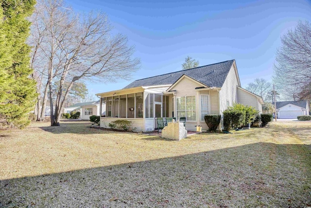 view of side of home with a yard and a sunroom