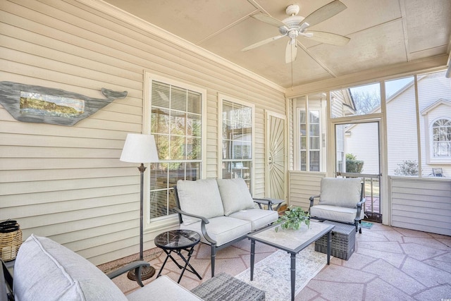 sunroom featuring ceiling fan