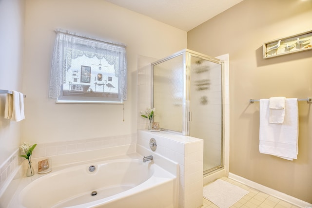 bathroom with separate shower and tub and tile patterned flooring