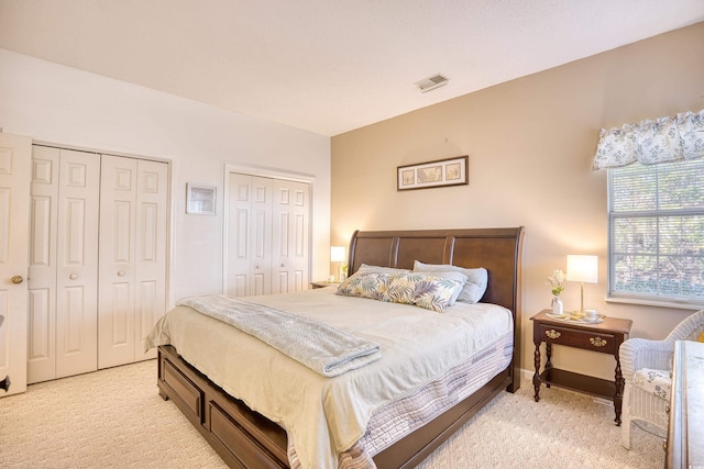 carpeted bedroom with multiple closets