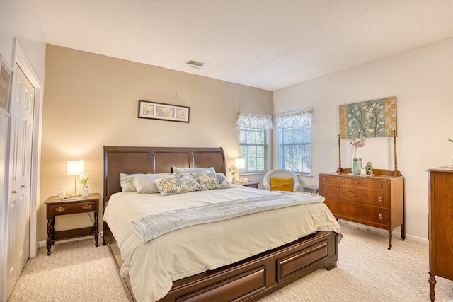 carpeted bedroom with a textured ceiling