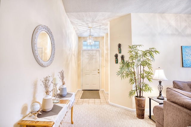 entrance foyer featuring carpet floors and a textured ceiling