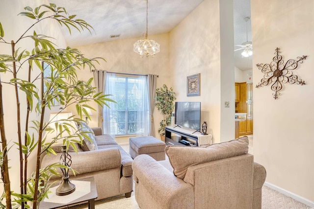 carpeted living room with ceiling fan with notable chandelier and a high ceiling