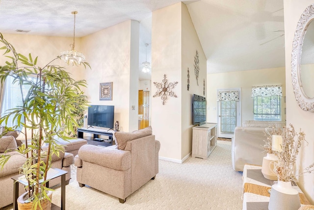 carpeted living room featuring a towering ceiling, a textured ceiling, and ceiling fan