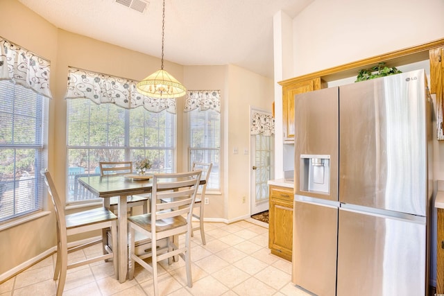 tiled dining area with a textured ceiling