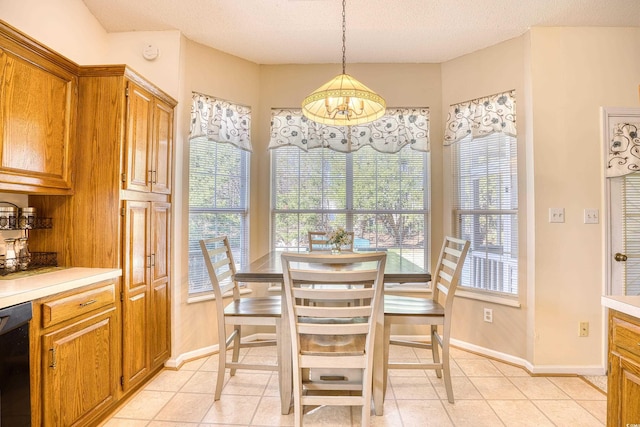 dining area featuring a textured ceiling and light tile patterned floors