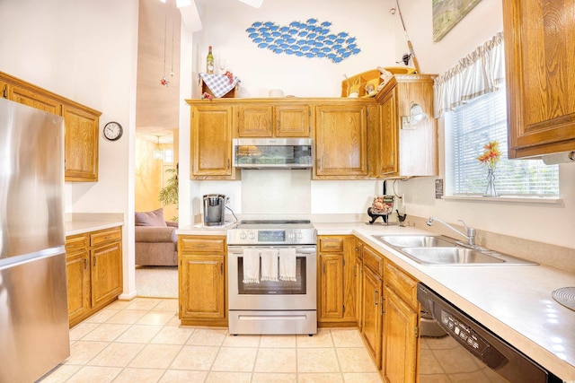 kitchen featuring appliances with stainless steel finishes, sink, and light tile patterned floors