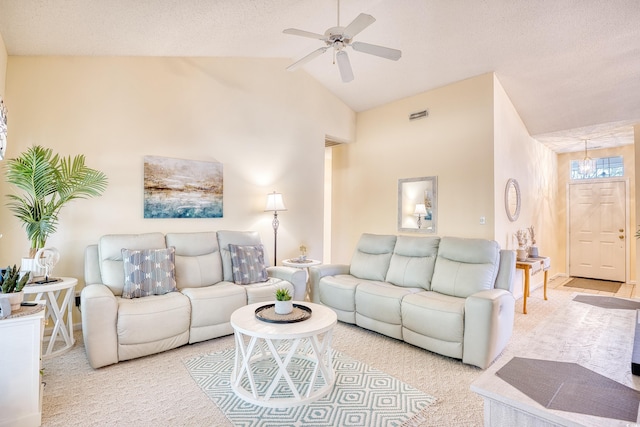 living room featuring a textured ceiling, vaulted ceiling, ceiling fan, and carpet flooring