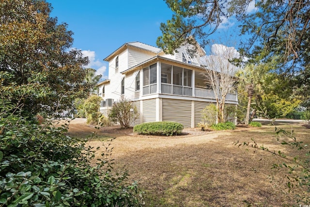 view of property exterior featuring a sunroom