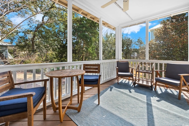 sunroom / solarium featuring ceiling fan