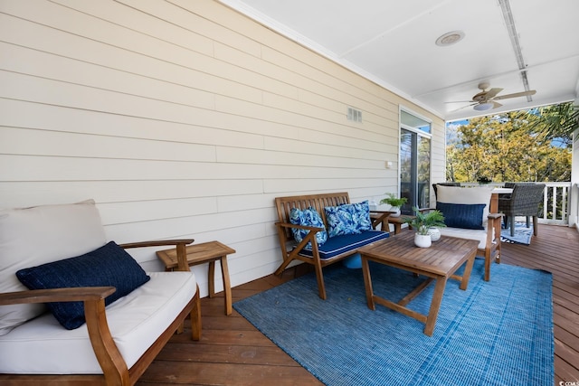 wooden deck featuring an outdoor hangout area and ceiling fan