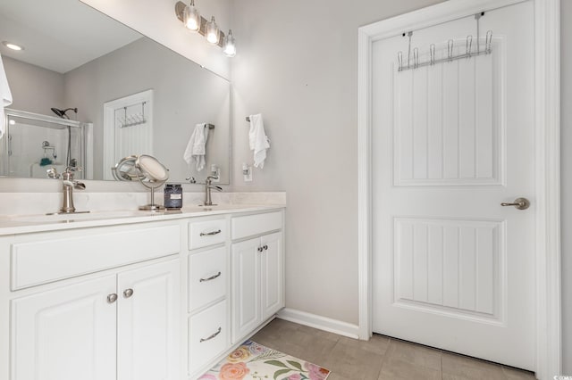 bathroom featuring tile patterned floors, a shower with door, and vanity