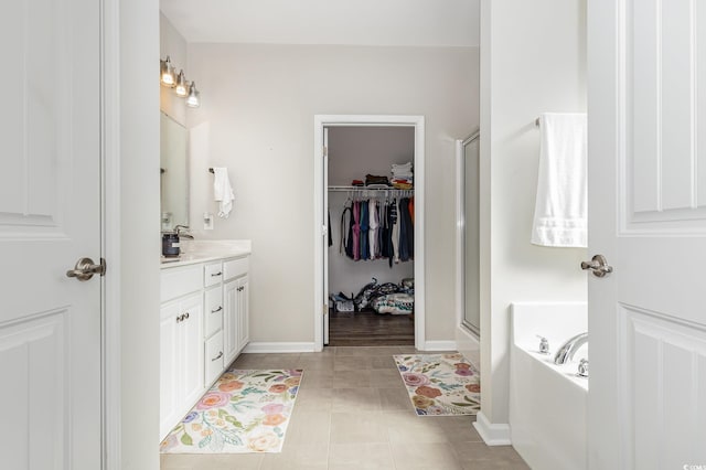 bathroom featuring vanity, tile patterned floors, and independent shower and bath