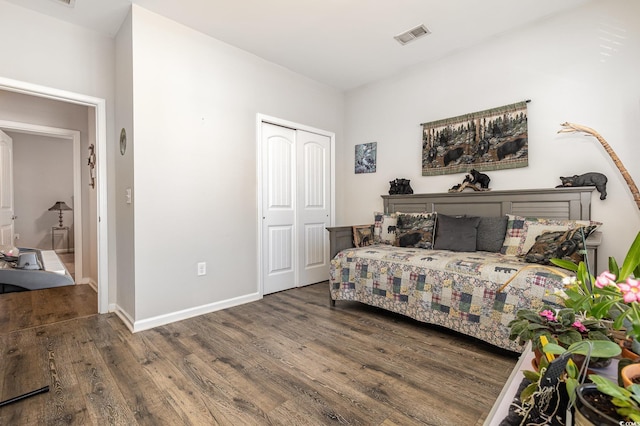 bedroom with hardwood / wood-style floors and a closet