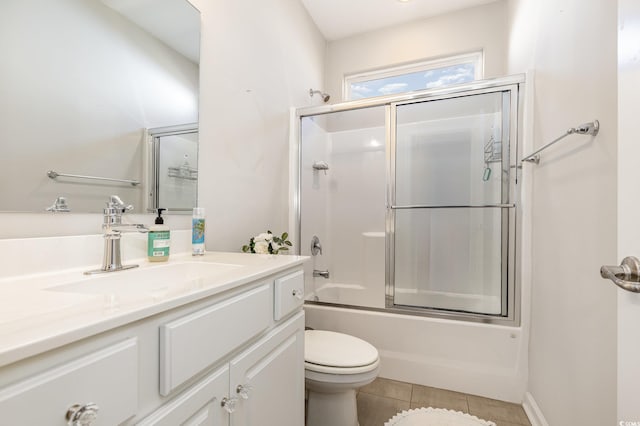 full bathroom with vanity, tile patterned floors, shower / bath combination with glass door, and toilet