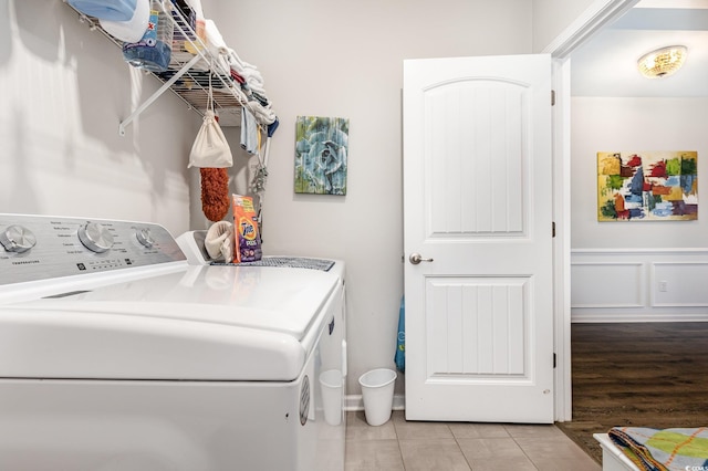 clothes washing area featuring light tile patterned floors and washing machine and dryer