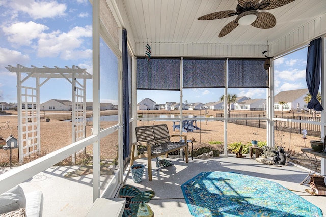 sunroom featuring ceiling fan