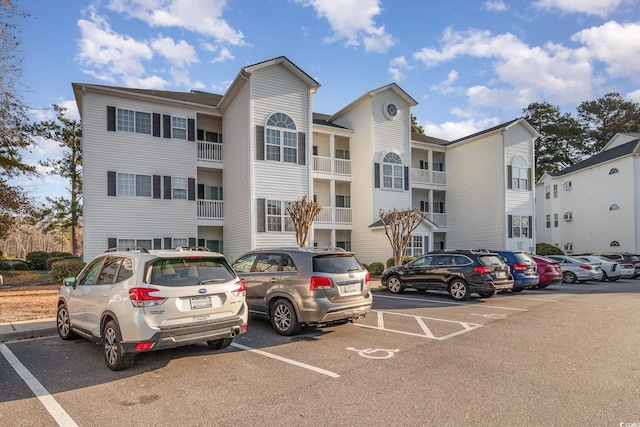 view of building exterior featuring uncovered parking