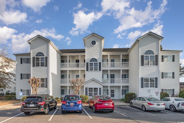 view of building exterior with uncovered parking